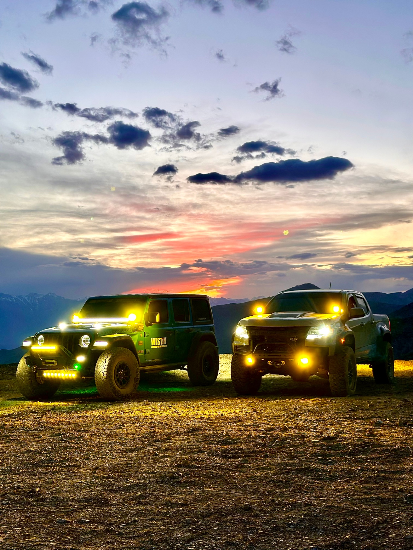 Jeep Rubicon and Chevy Colorado ZR2 parked at sunset above the Owens Valley near Cerro Gordo