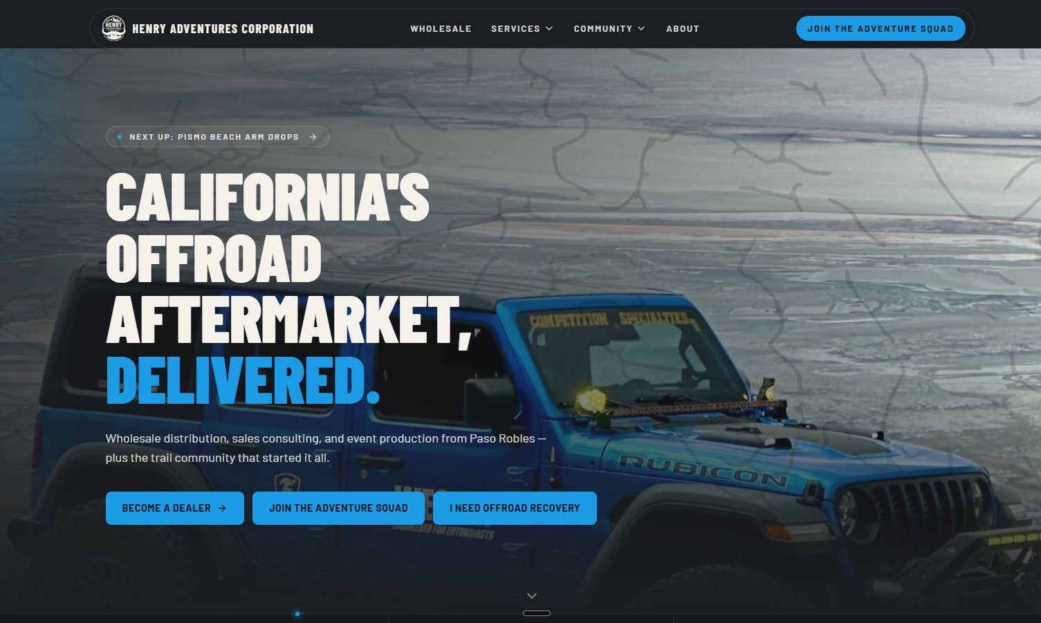 Henry Adventures homepage hero with a blue Jeep Rubicon on the beach